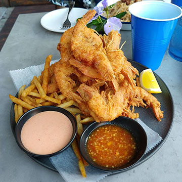 Pile of deep fried shrimp and fries
